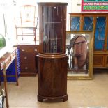 A mahogany corner cabinet with glazed bow-front door and cupboards under, on bracket feet, W57cm,