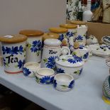 A quantity of Tony Raymond pottery, including storage jars, money boxes, flour sifter etc, with blue