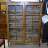 A 19th century Continental fruitwood bookcase, 2 lattice-glazed doors, on tapered legs, W117cm,