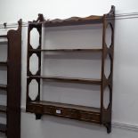 A mahogany 4-tier hanging open bookcase, with short drawers, W69cm, H93cm