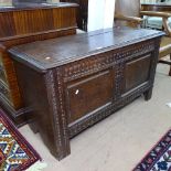 An 18th century joined oak coffer, with chip carved panelled front, on stile legs, W104cm, H60cm,