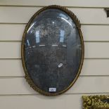 An oval gilt-metal picture frame, with convex glass and applied wheatsheaf decoration, length 52cm