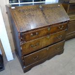 A Georgian oak bureau with 4 long graduated drawers, on bracket feet, W91cm, H100cm, D53cm