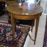 An Edwardian cross-banded mahogany and satinwood-strung circular lamp table on tapered legs,