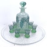 A bubble glass decanter set with grapevine decoration, and a glass plate