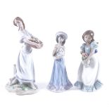 2 Lladro porcelain figures, model nos. 7704 and 5645, and a NAO figure of a girl holding an urn,