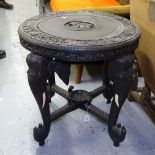 An Anglo-Indian chip carved circular table, on elephant carved supports