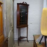 An oak corner cabinet on stand, with lattice-glazed door, W75cm, H203cm