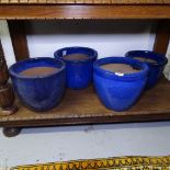 A set of 4 small blue glazed garden pots