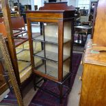 An Edwardian mahogany and satinwood-strung display cabinet, with a single glazed door, on square