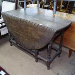 An Antique carved oak gateleg table, on baluster turned legs, W120cm, H72cm