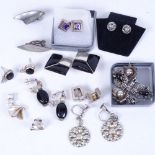 A tray of silver, marcasite, and black enamel earrings