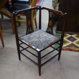 An Edwardian stained beech corner elbow chair, on turned legs