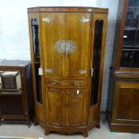 A good quality cross-banded mahogany cocktail cabinet of canted form, with 4 panelled doors