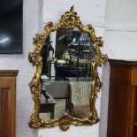 A modern gilt-framed shield-shape wall mirror, W60cm, H90cm