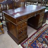 A reproduction mahogany twin-pedestal writing desk, with 3-section tooled leather top, and 9