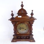 A carved mahogany-cased mantel clock, with brass dial and mounts, and 2-train movement, height 50cm