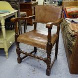 A studded leather upholstered oak elbow chair