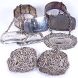An Art Nouveau silver nurse's buckle with scrolled floral and cherub decoration, 3 silver decanter