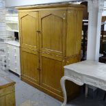 An early 20th century pine 2-section 4-door office cabinet, the top section fitted with pigeon holes