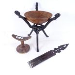 A hardwood headrest, an African hardwood comb, and a hardwood bowl on folding stand (3)