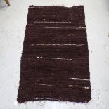 A purple/mauve Kilim rug