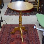 A modern Ercol light elm lamp table on tripod base, W50cm, H75cm