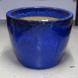 A blue glazed terracotta garden pot