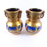 A modern pair of Egyptian Revival painted and gilded vases, height 30cm