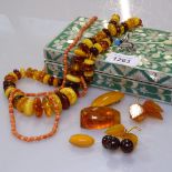 A polished amber disc design necklace, amber brooches, a coral necklace etc