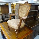 A Victorian mahogany open armchair, with upholstered shield back, on turned legs