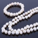 A Baroque pearl long necklace, length 58cm, and matching elastic-strung bracelet