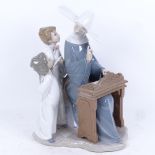 A large Lladro group of a nun at a harpsichord with 2 choristers, height 33cm