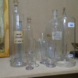 Engraved Chemist's glass measure, height 36cm, smaller glass measures, and bottles etc