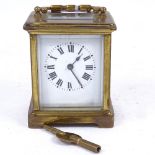 A brass-cased carriage clock, white enamel dial with Roman numeral hour markers and blued steel
