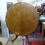 A 19th century circular tilt-top breakfast table, with turned centre column and sabre leg base,