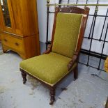 An Edwardian carved walnut-framed and upholstered nursing chair