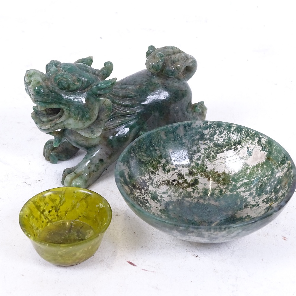 A Chinese miniature carved and polished jadeite temple dog, a moss agate bowl, and another (3)