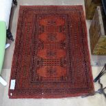 A red ground Afghan design rug, 135cm x 95cm