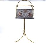 An early 20th century brass and copper tripod swivel magazine rack, height 84cm