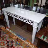 A white painted rectangular console table, with lattice weave frieze, on square tapered legs,