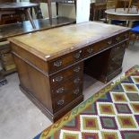 A mahogany twin-pedestal writing desk, with brown leather skiver and 9 fitted drawers, W150cm,