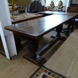 A large early 20th century rectangular oak refectory table, on heavy acanthus leaf carved baluster