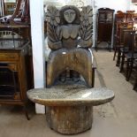 A mid-century north European large figural carved tree trunk chair, with rising seat, W100cm, H147cm