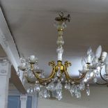 An 8-branch gilt-metal chandelier with pear-shape crystal drops