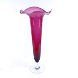 A large cranberry glass trumpet vase, height 50cm