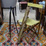 A small French folding campaign chair, and a leather-cased military tripod