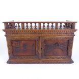 A Grand Tour style carved mahogany wall-hanging cabinet, with Venetian scene carved panel doors,