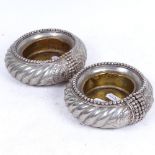 A pair of African/Omani slave bangles converted into dishes with brass bases, 12cm