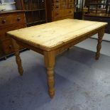 A polished pine farmhouse kitchen table, on baluster turned legs, L152cm, H77cm, D95cm